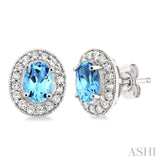 7x5mm Oval Cut Blue Topaz and 3/8 Ctw Round Cut Diamond Earrings in 14K White Gold